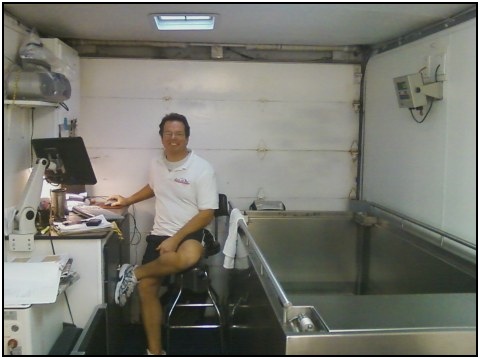 Brian smiling, while sitting next to the hydrostatic weighing tub.