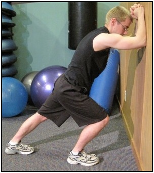 Standing calf stretch against the wall, position 2.