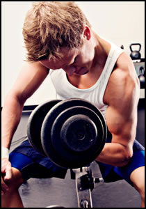 A man doing weight training sets with a dumbbell.