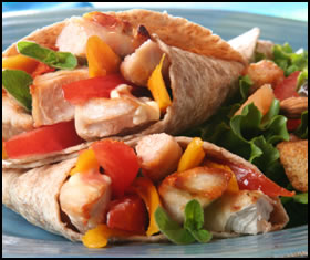 Healthy weight training foods, like this whole wheat tortilla with chicken and veges, will help your gain muscle faster.